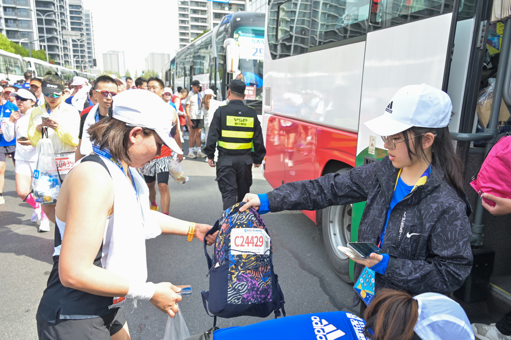 志愿者为参赛者存取背包